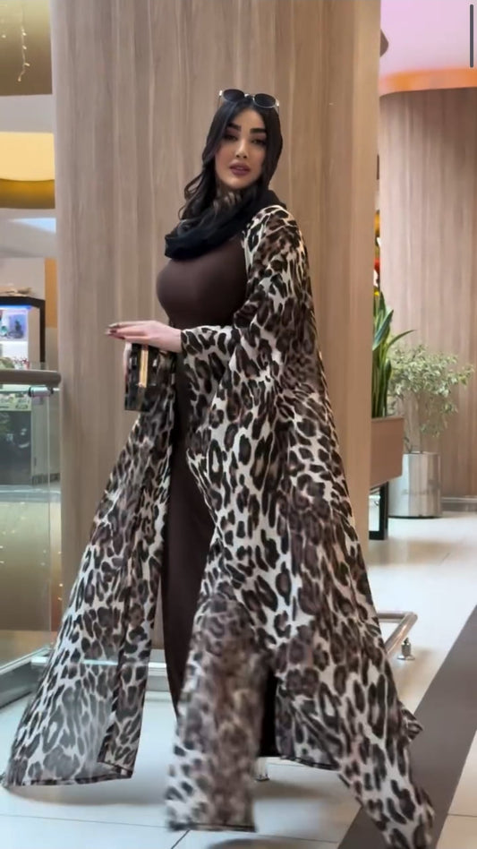 Woman wearing a leopard print coat in an indoor setting